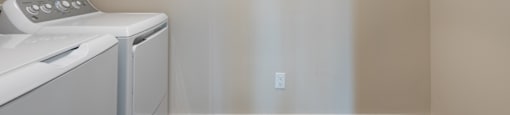 a laundry room with a washer and dryer