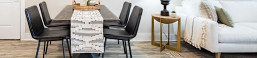 a dining room with a table and chairs