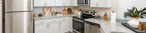 a modern kitchen with white cabinets and stainless steel appliances