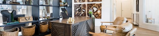 a home office with a black and white chevron desk and leather chair