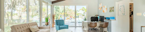 a living room with a couch chairs and a coffee table in front of a sliding glass door