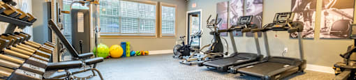 A large gym with equipment at Amelia Village apartments in Clayton, NC.