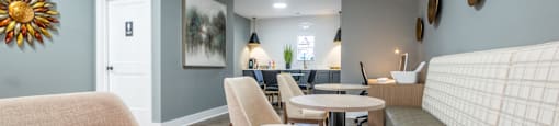 A common area with a wooden table and chairs at Amelia Village apartments in Clayton, NC.
