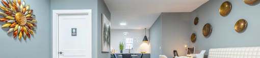 A common area with blue walls and white furniture at Amelia Village apartments in Clayton, NC.