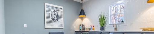 A common space with a white table and black chairs at Amelia Village apartments in Clayton, NC.