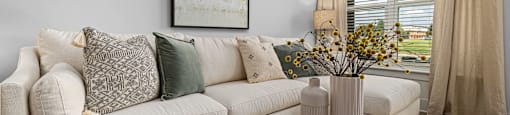 Altitude Raleigh living area within model apartment home with large windows and an open floor plan