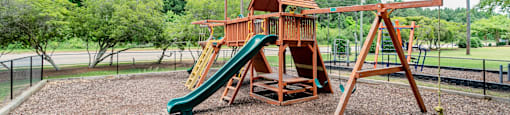 a playground with a swing set and a slide