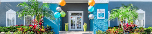 a blue building with balloons in front of it