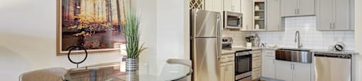 A modern kitchen with a glass table and chairs, a fridge, a microwave, and a painting on the wall.