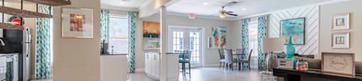 a resident clubhouse with a staircase leading up to the second floor