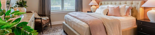 Bedroom with a Large Bed, Two Nightstands, Dresser and a Ceiling Fan.