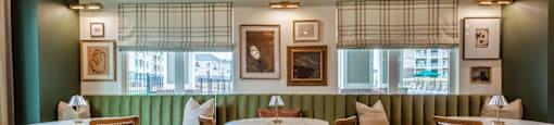 Inside the Clubhouse with a Restaurant including Green Walls and Wooden Chairs.