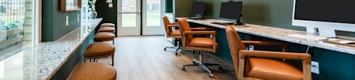 Modern Business Center with Wood Floors and a Long Bar Table.