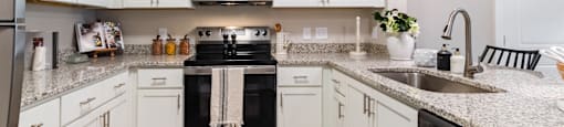 Kitchen with White Cabinets and a Granite Countertop.