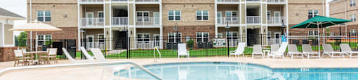 Side View of the Pool with Loungers and Umbrellas.