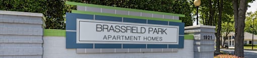 the sign apartment homes in front of a brick wall