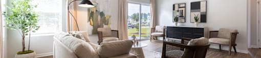 a living room with a couch and a chair and a table