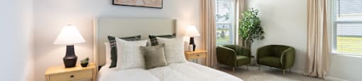 a white bedroom with a white bed and a ceiling fan