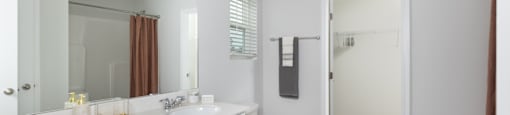 a bathroom with a toilet and a sink and a mirror
