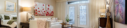 A living room with a white couch and a ceiling fan.