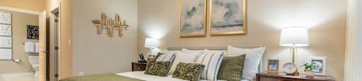 A bedroom with a large bed and a ceiling fan.