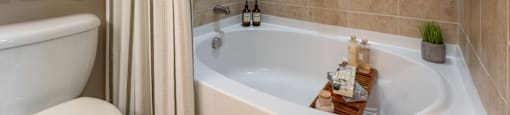 A bathroom with a white tub and a shower curtain.