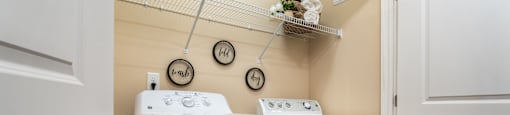 A white washing machine and dryer in a small laundry room.