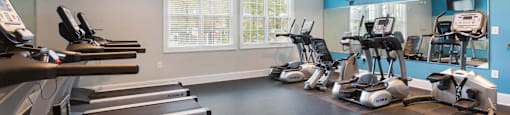 A gym with treadmills and exercise bikes.