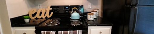 a small kitchen with black appliances and white cabinets