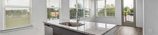 Altitude Raleigh kitchen with granite countertops and stainless steel appliances