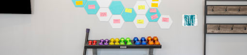 the gym has a variety of weights and dumbbells on display and a colorful