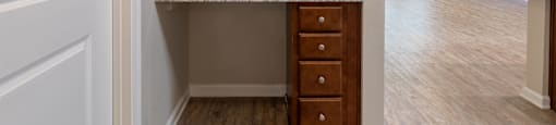an empty kitchen with wooden cabinets and granite counter top