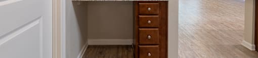 an empty kitchen with wooden cabinets and granite counter top