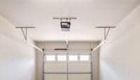 A white room with a closed white door in the middle.