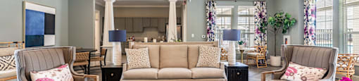 a living room with couches and chairs