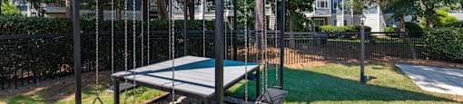 a playground with a swing set and a ping pong table