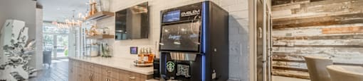 the lobby of a restaurant with a coffee machine on the counter