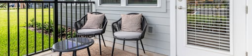 A patio with a table and two chairs.