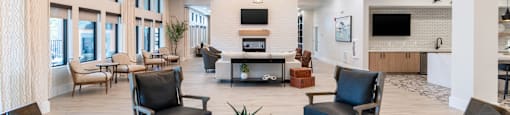 A spacious living room with a high ceiling and a central coffee table.