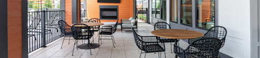 A patio with a table and chairs and a ceiling fan.