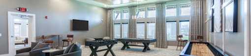 A room with a pool table and a television.