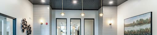 A reception area with a white reception desk and a framed painting on the wall.
