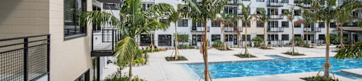 a view of the pool from a balcony of an apartment building