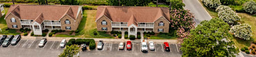 an aerial view of a neighborhood with houses and parking lot