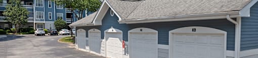 a row of garages in front of an apartment building