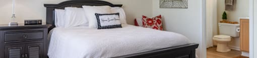 a bedroom with a large bed and a ceiling fan