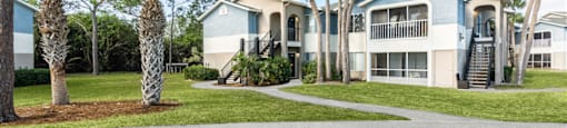 a home with palm trees in front of it
