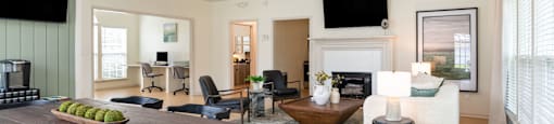 a living room with a fireplace and a dining table
