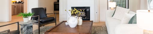 a living room with a white couch and a coffee table and a fireplace