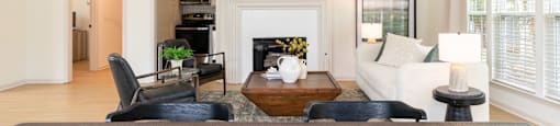 a living room with a table with a bowl of fruit on it